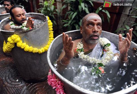 Những tín đồ Hindu đang hát thánh ca trong lễ hội cầu mưa Varuna Yajna tại Sankara Mattham, Mumbai. Mười tín đồ sẽ phải ngâm mình trong nước suốt 4h đồng hồ để cầu mưa.